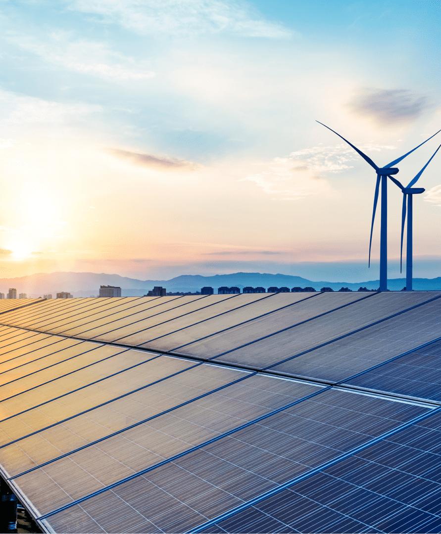 Solar panels and wind turbines at sunset.
